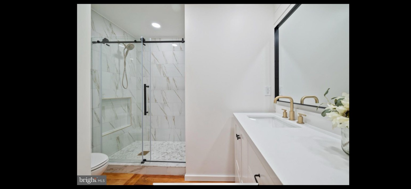 Master bathroom after full remodel - floor to ceiling tile walk-in shower and double vanity